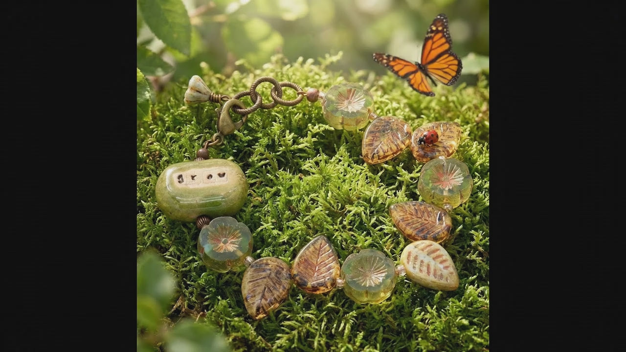 Video of a colorful beaded bracelet with a focal that reads Grow and a butterfly softly batting its wings