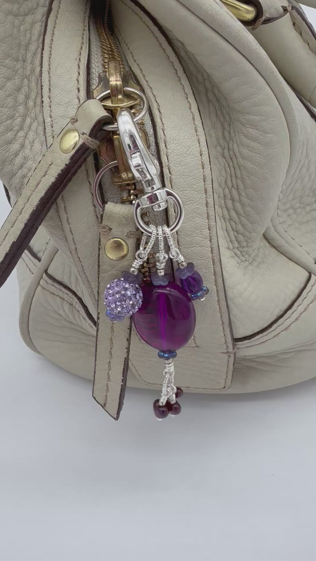 Video of a violet purple handbag charm with Lucite, pave and Czech glass hearts - handmade with love by Ruby Acorn