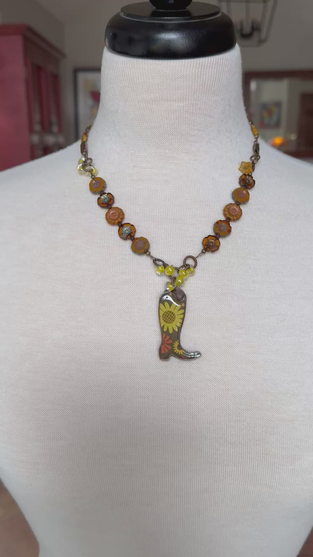 Video of colorful necklace with cowboy boot pendant