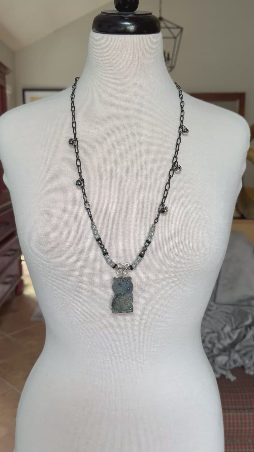 Video of a mannequin wearing a long necklace with a labradorite carved owl focal, Czech glass, lampwork glass teardrops and noir chain - art you can wear by Ruby Acorn