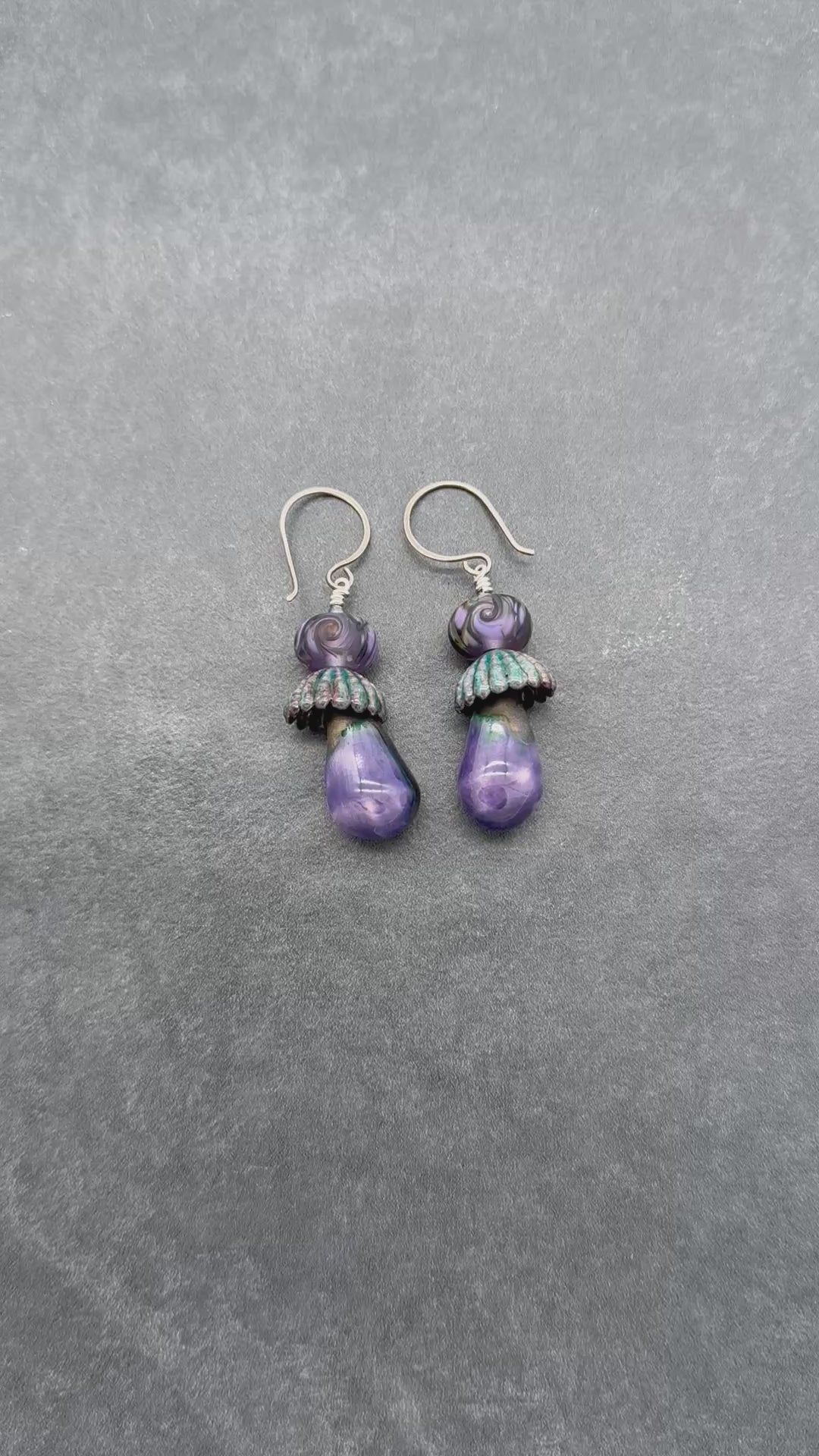 Video of purple swirl hand crafted earrings with sterling silver ear wires.