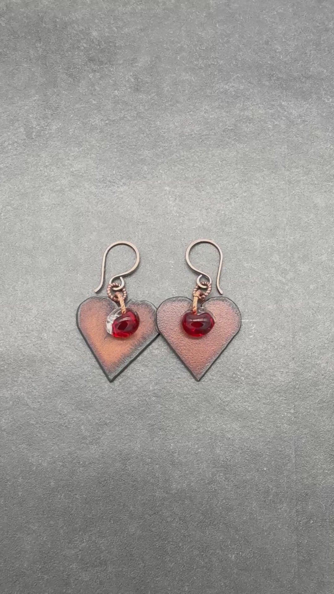 Video of heart-shaped earrings with red lampwork glass teardrops