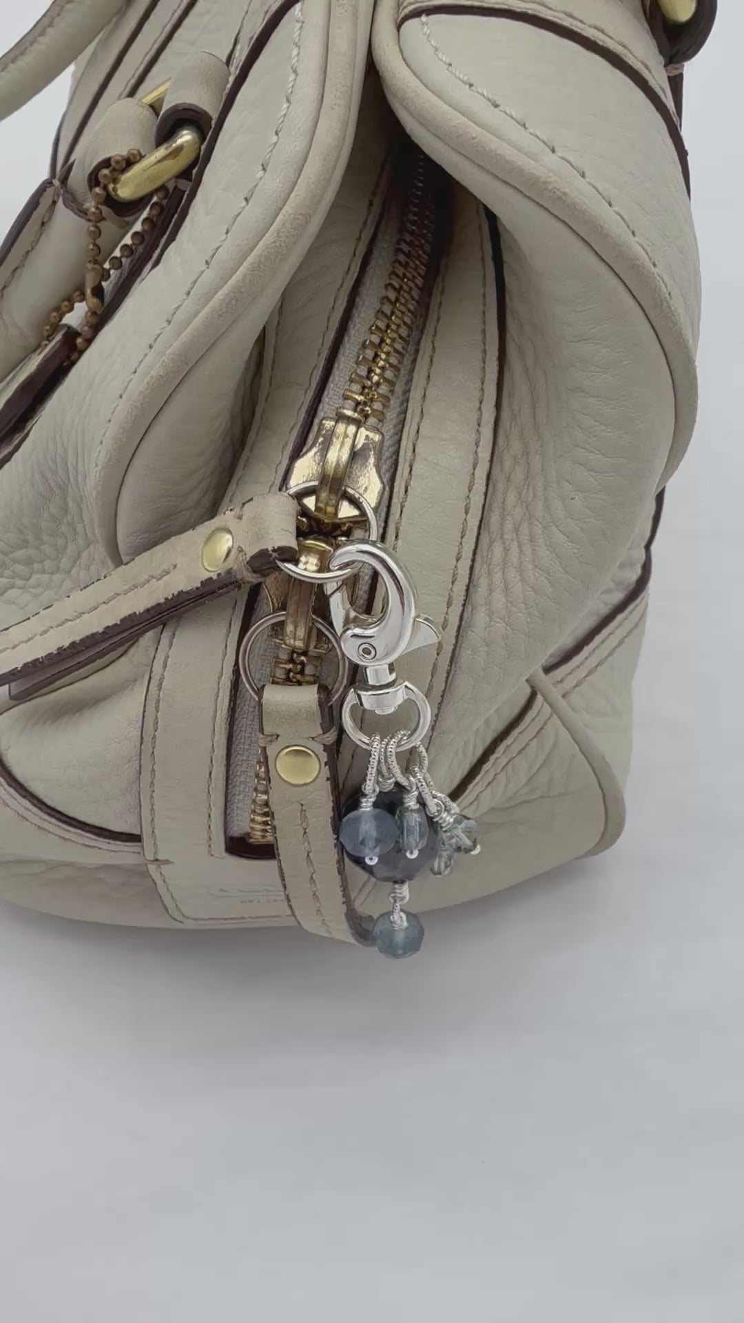 Video of Winter's Hush zipper pull displayed on a handbag, made with love in Colorado by Ruby Acorn.