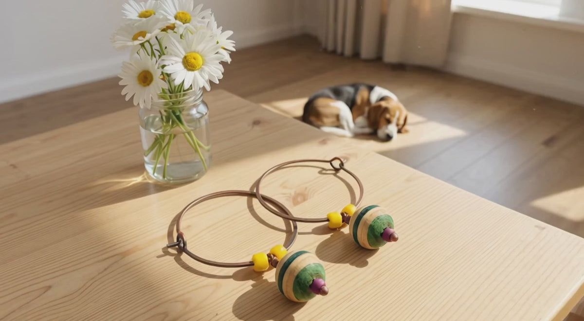 Recycled Skateboard Earrings with a sleeping beagle nearby. 