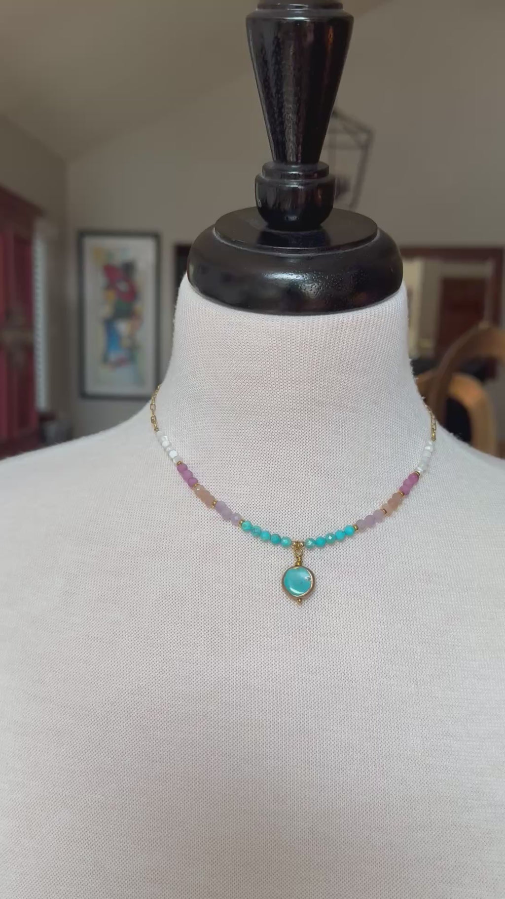 Video of a multi gem gold chain choker necklace with genuine turquoise focal, kunzite, peach moonstone, and more on a mannequin - made with love by Ruby Acorn