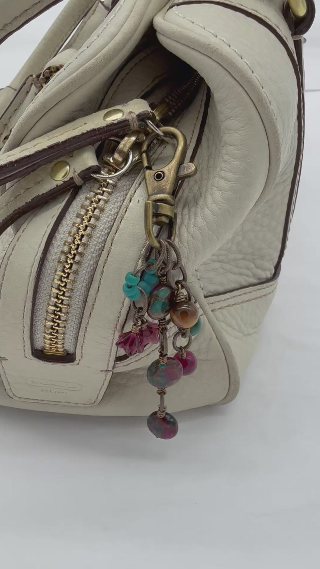 Video of Mosaic in Bloom Handbag Charm featuring mosaic agate bead with fuchsia, turquoise and earth tones, handmade by Ruby Acorn