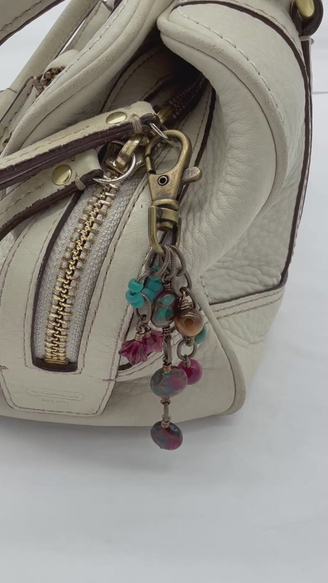 Video of Mosaic in Bloom Handbag Charm featuring mosaic agate bead with fuchsia, turquoise and earth tones, handmade by Ruby Acorn