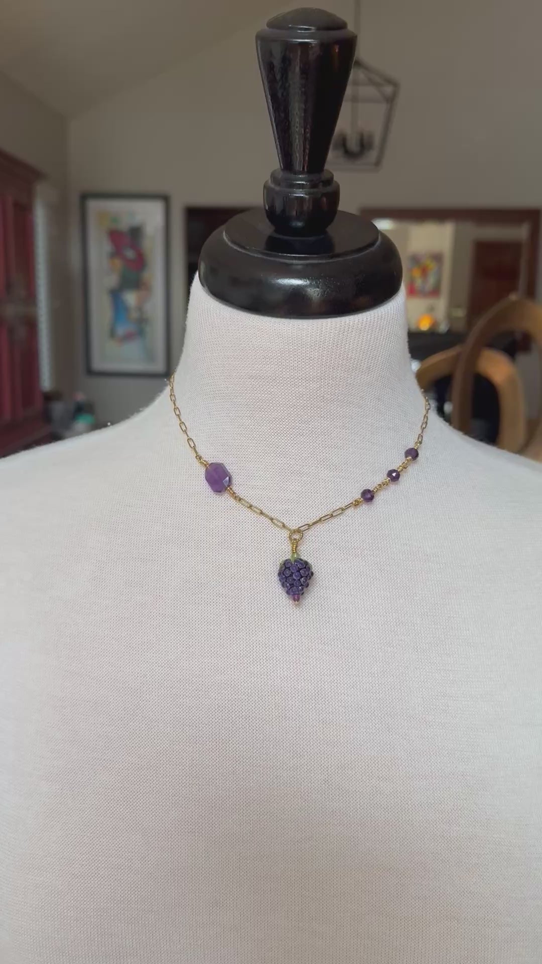 Video of a mannequin wearing an asymmetrical gold chain necklace with artisan lampwork glass blackberry focal and amethyst - handmade with love by Ruby Acorn
