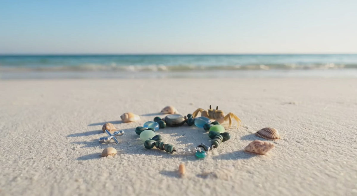 A video of Blue Skies Bracelet with a little crab on a sandy beach.