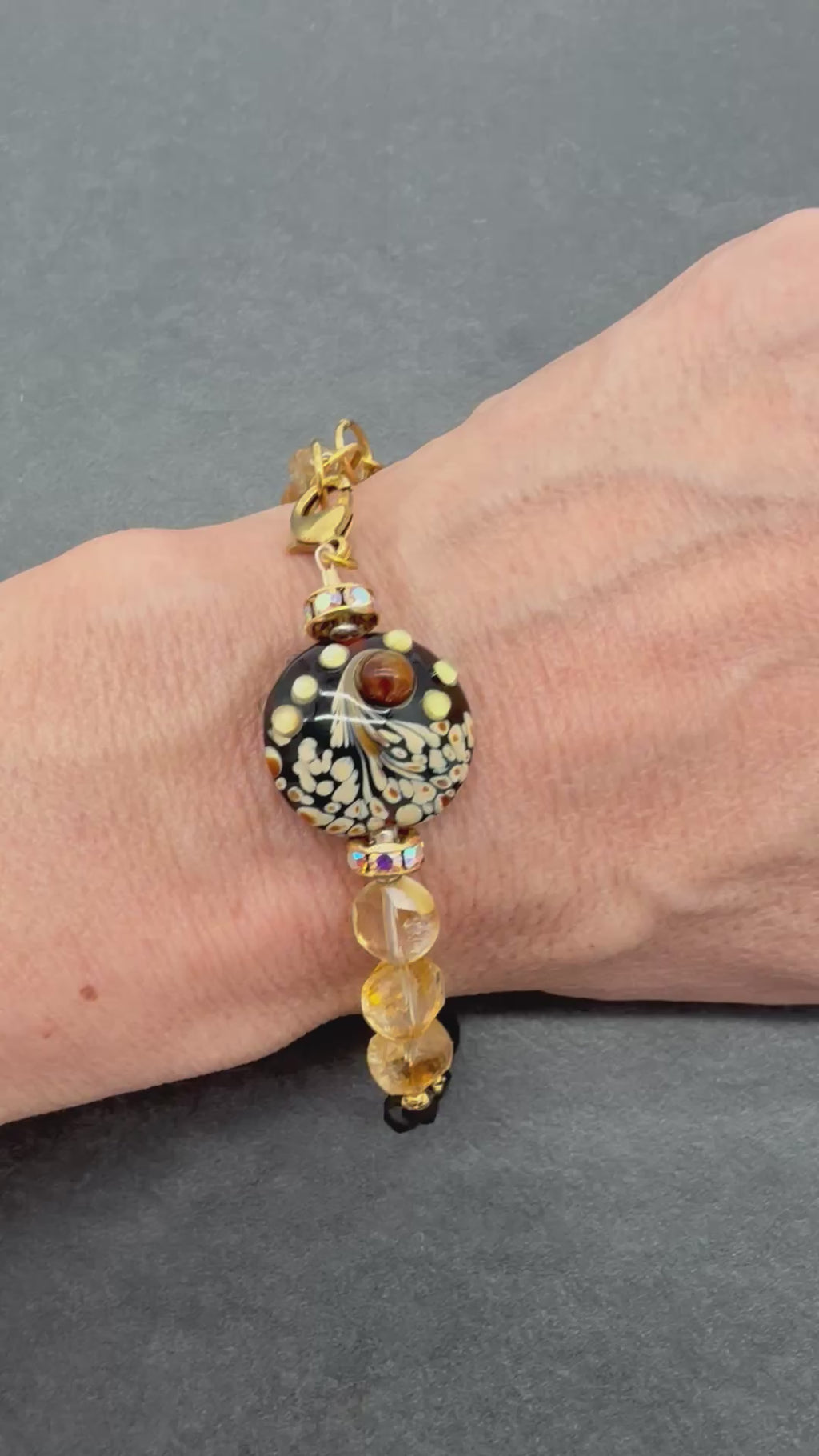 Video of Solstice Luxe Bracelet featuring artisan lampwork glass focal with smoky quartz and citrine faceted coins, handmade by Ruby Acorn