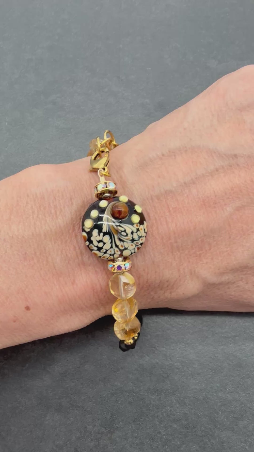 Video of Solstice Luxe Bracelet featuring artisan lampwork glass focal with smoky quartz and citrine faceted coins, handmade by Ruby Acorn