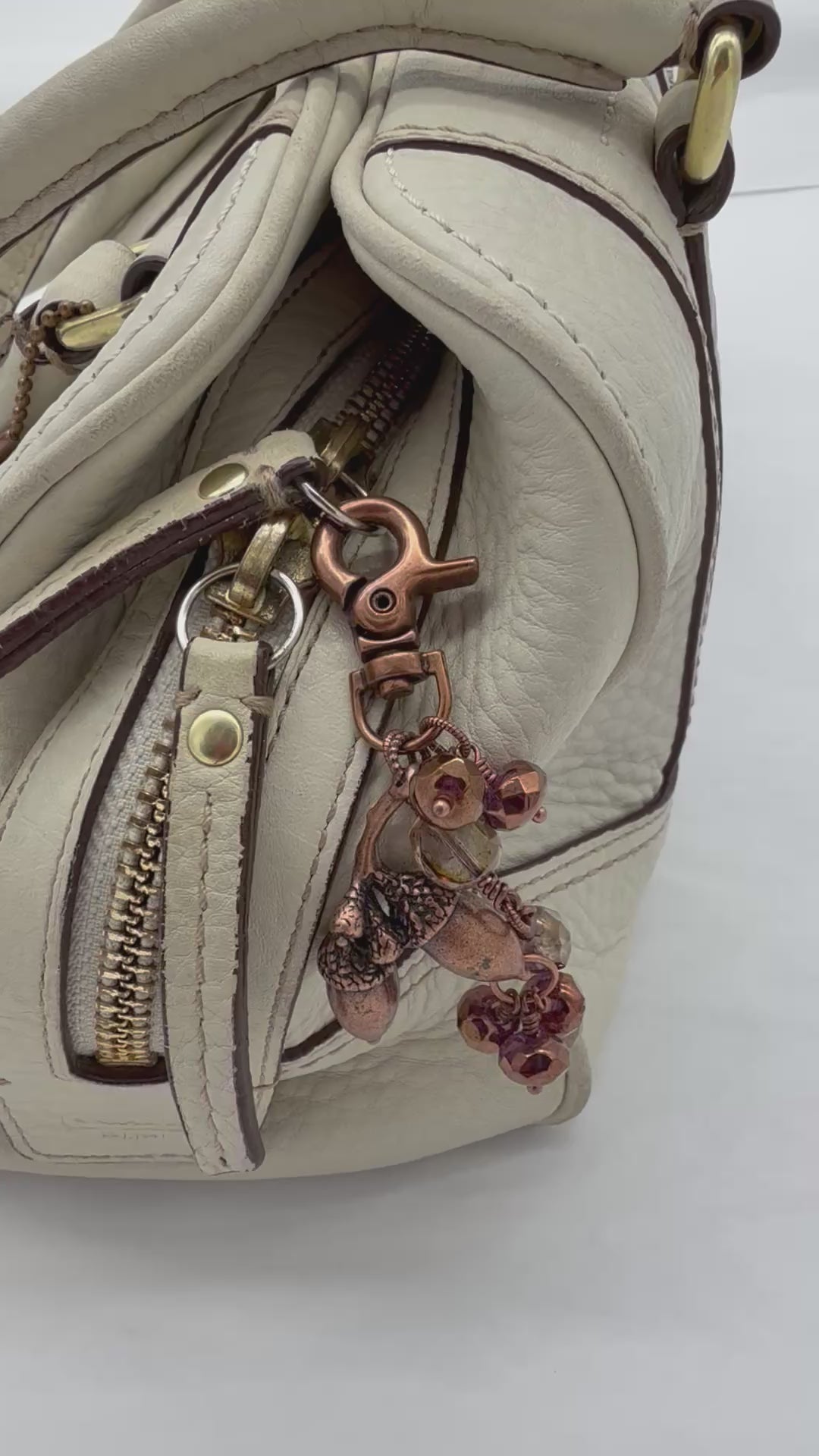 Video of The Acorn Keeper Handbag Charm featuring a rare antique copper acorn focal with light topaz Czech glass charms, handmade by Ruby Acorn