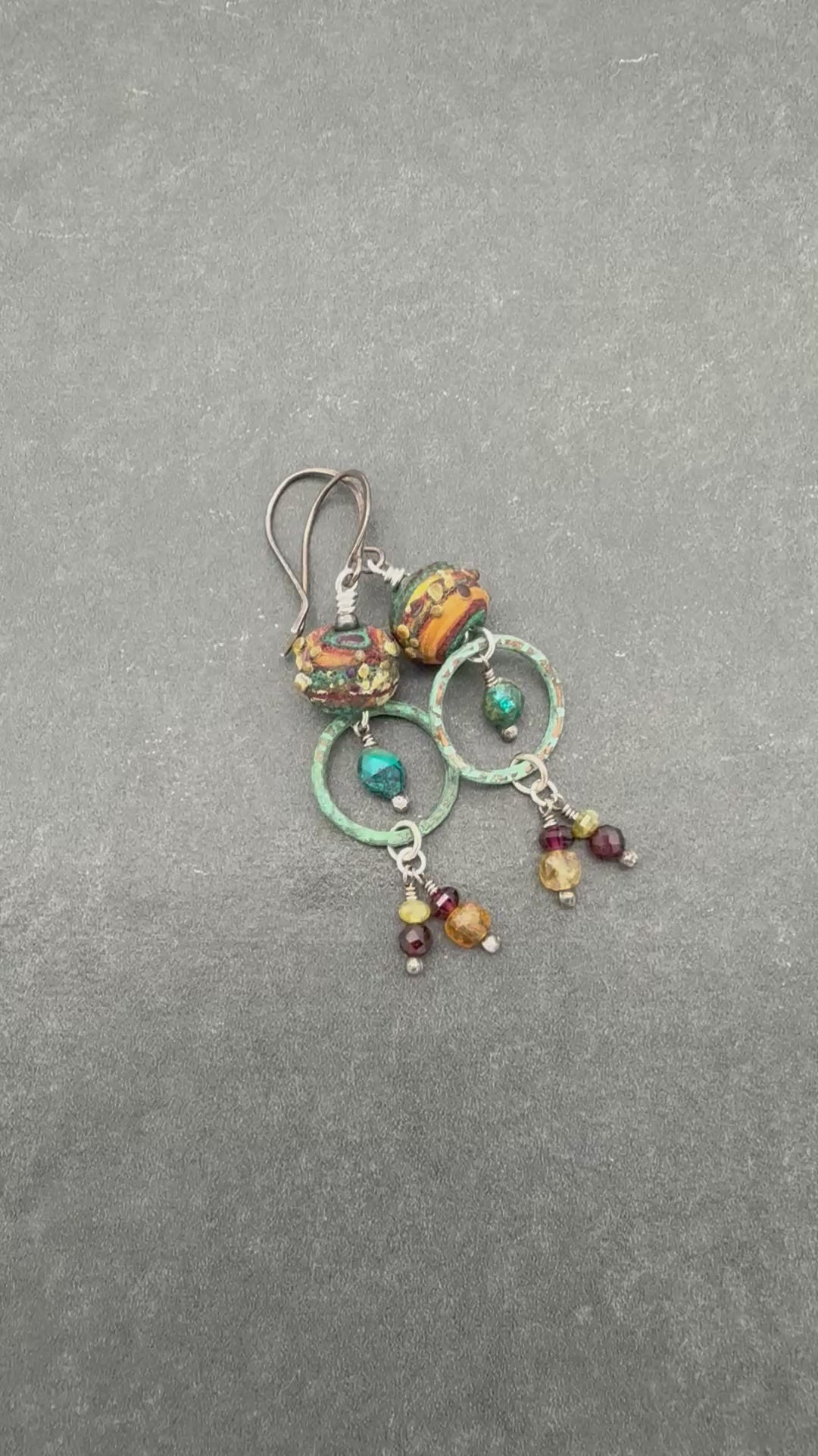 Video hand holding Autumn Berries earrings