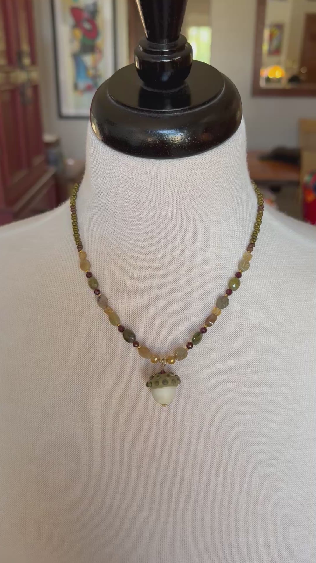 Video of Forest Fable Necklace featuring artisan lampwork glass acorn focal with green garnet, red garnet and citrine, handmade by Ruby Acorn