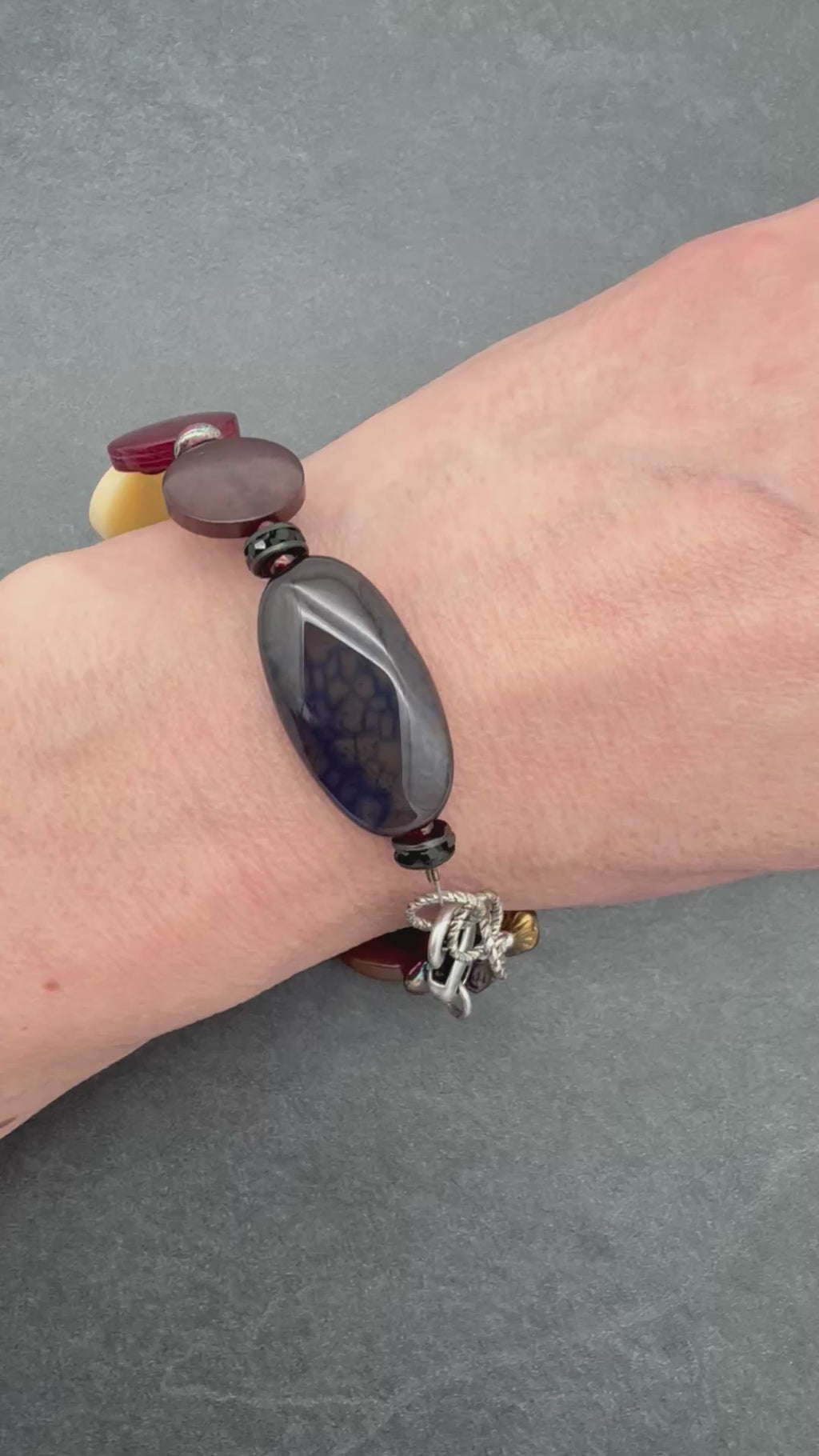 Video of hand wearing colorful beaded bracelet