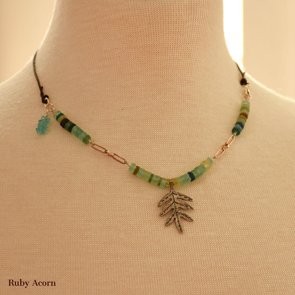 Necklace with ancient Roman glass beads, silver leaf focal on a bust